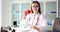 Female doctor holds red toy heart in hands closeup