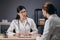 A Female Doctor Interviewing a Male Patient