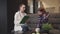 Female doctor listening girl and writing while sitting on sofa in home interior.