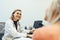 Female doctor listening to her patient during consultation