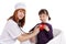 Female doctor and little girl holding plush heart