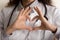 Female doctor making hand and finger heart shape