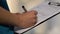 Female doctor making records, writing down medication prescription, close-up