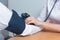 A female doctor measures the blood pressure of a male patient during a medical examination to prevent hypertension and