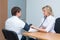 A female doctor measures the blood pressure of a male patient during a medical examination to prevent hypertension and