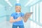 Female doctor in the medical interior of the hospital holds a tablet, notepad. Cartoon person. 3D rendering