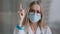 Female doctor in medical mask looking at camera talking angry show index finger no negative gesture mad stressed woman