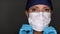 Female Doctor or Nurse Putting On Medical Face Mask