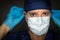 Female Doctor or Nurse Wearing Surgical Gloves Putting On Medical Face Mask