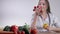 A female doctor or nutritionist sitting at the table and holding with different fruits and vegetables. Healthcare