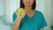 Female doctor offering green apple, healthy lifestyle diet concept, dental care