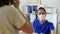 Female doctor offering mask to patient at hospital