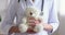 Female doctor pediatrician holding teddy bear in hands, close up