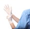 Female doctor putting on rubber gloves against white, closeup. Medical object