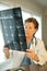 Female Doctor Reading MRI Film Scans