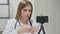 Female Doctor Recording Video on Smartphone