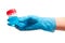 Female doctor\'s hand in blue glove holding transparent plastic sterile specimen collection contain