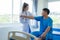 Female doctor\'s hand doing physiotherapy stretching the shoulder of a male patient.