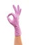 Female doctor\'s hand in purple surgical glove showing OK sign