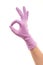 Female doctor\'s hand in purple surgical glove showing OK sign