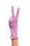 Female doctor\'s hand in purple surgical glove showing victory sign