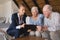 Female doctor and senior couple discussing over clipboard