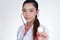 female doctor showing stethoscope for checkup over white background. physician or medical practitioner holding stethoscope to