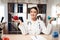 Female doctor sitting at desk in office with microscope and stethoscope. Woman is holding apple and dumbbell.