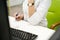 Female doctor sitting at a desk in a white medical coat