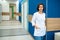 Female doctor standing in clinic corridor