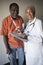 Female Doctor Standing With Disabled Patient