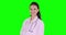 Female doctor standing in studio and smiling