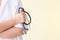 Female doctor with stethoscope in hands blur background.