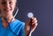 Female doctor with a stethoscope listening, isolated on gray background