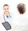 A female doctor with a tablet showing information to a patient