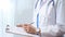 Female doctor taking notes on clipboard. Close-up of a unrecognizable female healthcare professional writing and filling