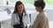 Female doctor talk to little patient during visit in clinic