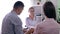 Female doctor telling bad news about health to young couple, man comforting his sad wife in medical office