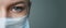 A female doctor therapist in a white robe, mask and gloves. Face close-up. The doctor cries and prays. Tears in eyes