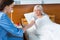 Female doctor in uniform is doing an injection to her patient