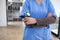 Female doctor in uniform holding a stethoscope waiting to examine a patient. A female doctor holds a stethoscope to prepare for