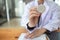 Female doctor in uniform holding a stethoscope waiting to examine a patient. A female doctor holds a stethoscope to prepare for