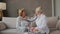 A female doctor uses a stethoscope to listen to the heart of an elderly patient