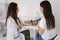 Female doctor using sphygmomanometer with stethoscope checking blood pressure to a patient in the hospital. Young woman