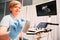 Female doctor using ultrasound scanner in clinic.