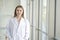 Female doctor wear white long lab coat in the laboratory room.