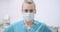 Female doctor wearing protective mask on face and put glasses. Doctor at Healtcare Clinic