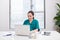 A female doctor working on medical expertise while sitting at desk in front of laptop