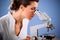 Female doctor working with a microscope