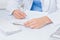 Female doctor writing prescriptions at table